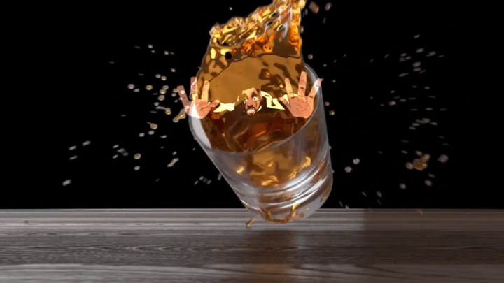 Man rolling from a glass full of whisky