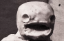 Clay man eats blueberry